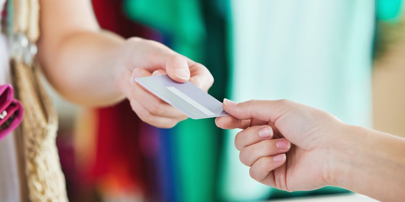Close-up of a woman paying with her credit card in a shop