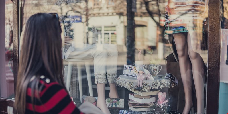 Woman staring at a shopping window at Avinguda del Portal de l'Àngel, Barcelona
