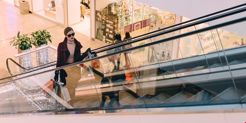 woman on a escalator in a shopping mall, Barcelona