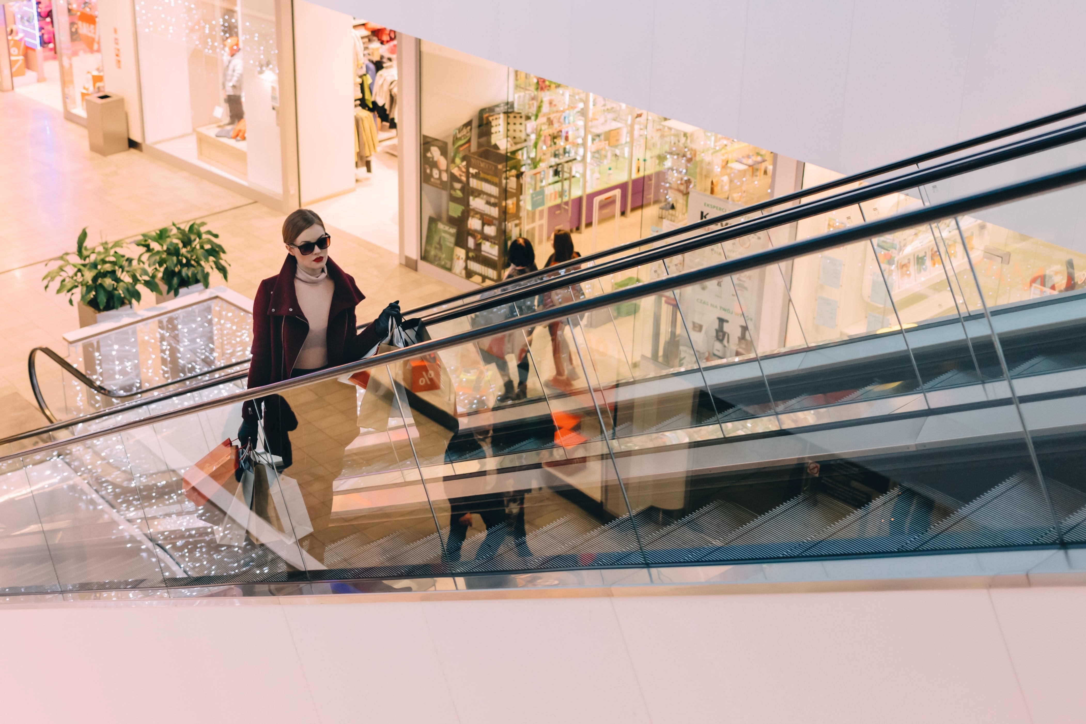 woman on a escalator in a shopping mall, Barcelona