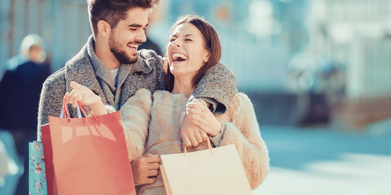 Couple carrying shopping bags and enjoying.