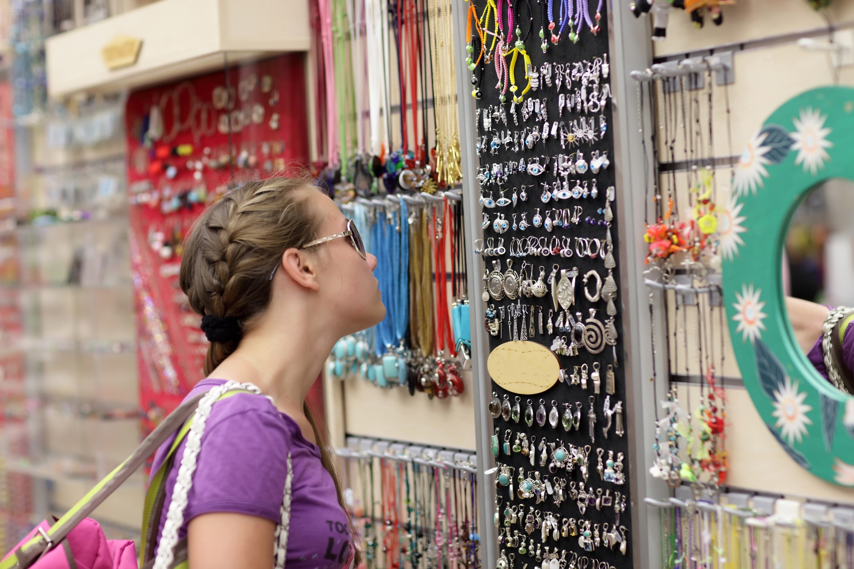 The girl is choosing souvenir at a greek market, Athens