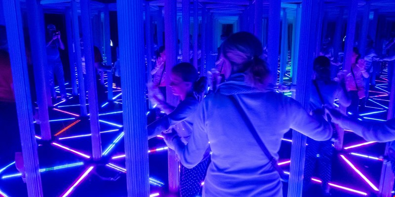 person in a mirror room