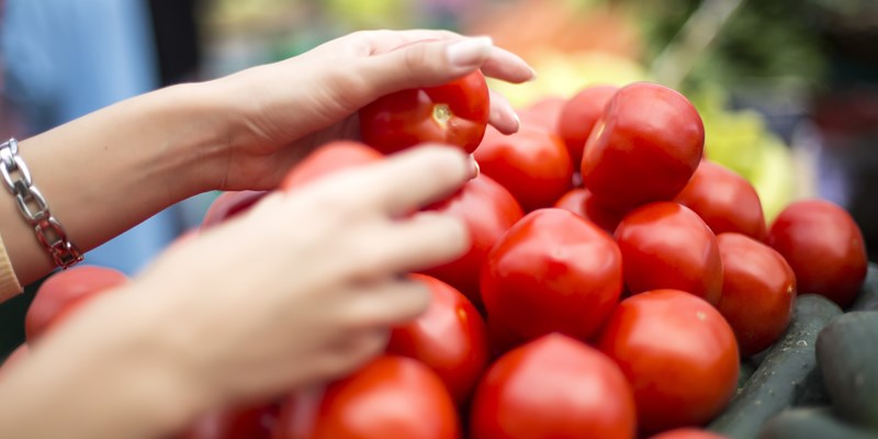 Woman buying fresh vegetables on the market