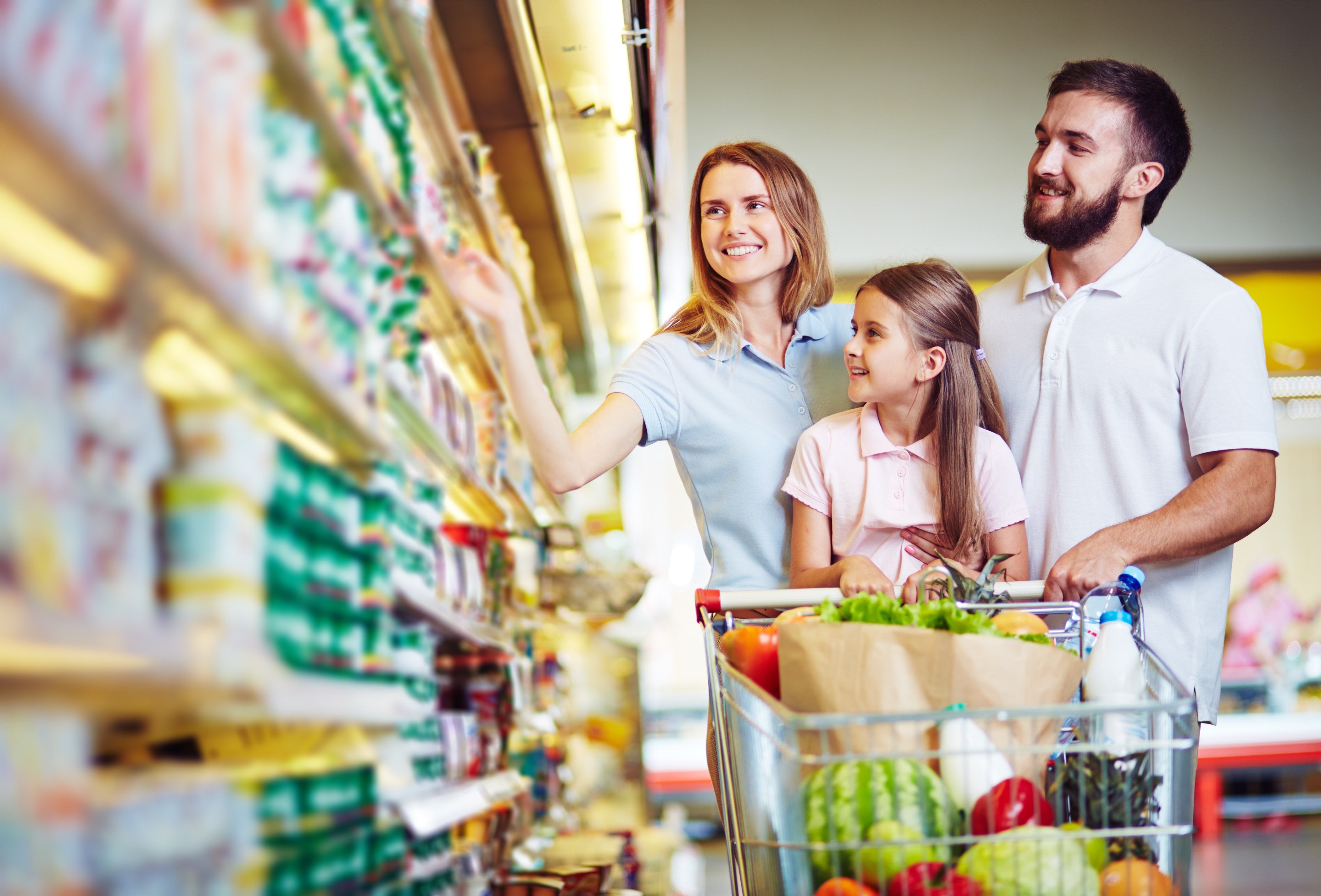 Happy family choosing dairy products in supermarket
