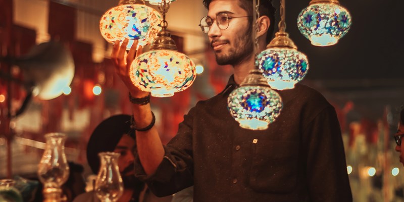 young man looking at traditional lanterns