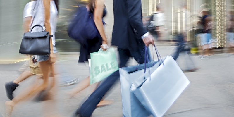 People in the street with shopping bags