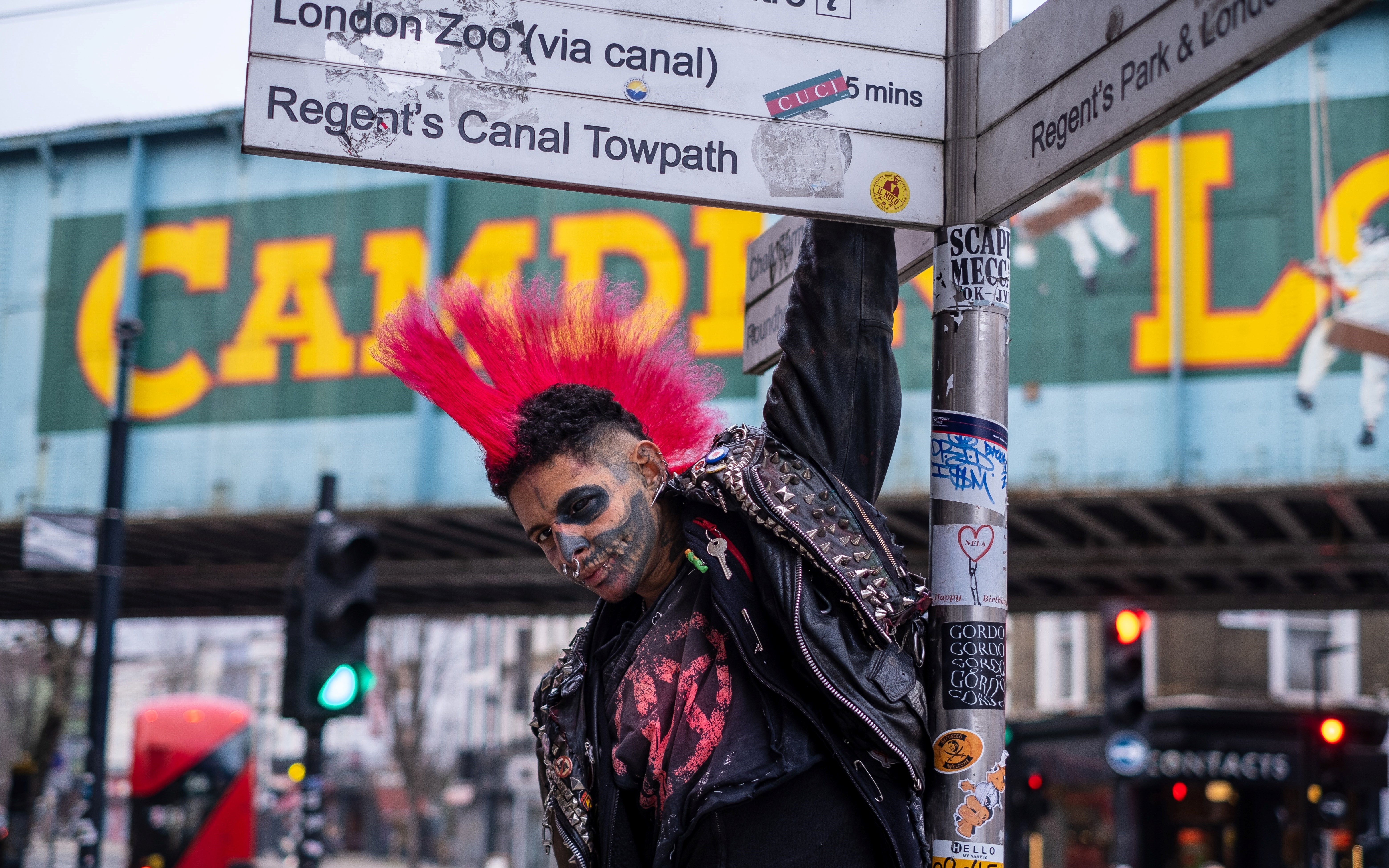 punk with a pink mohawk in from of the Camden Lock sign, London, the United Kingdom