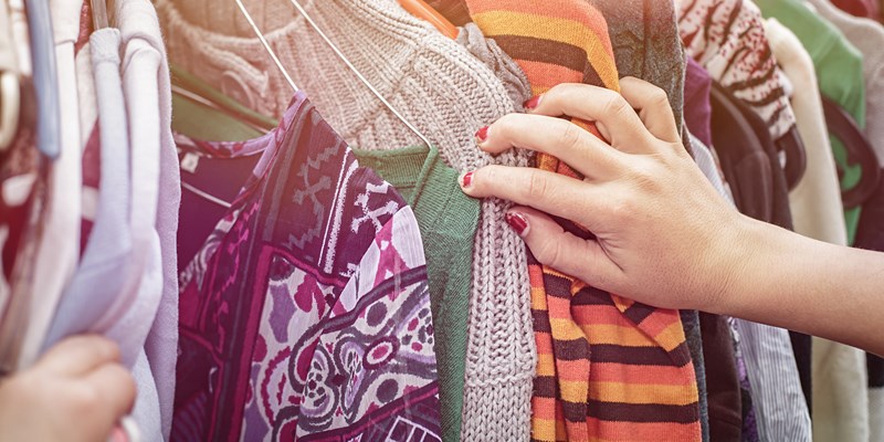 close up of a hand, looking on a flea market for clothes