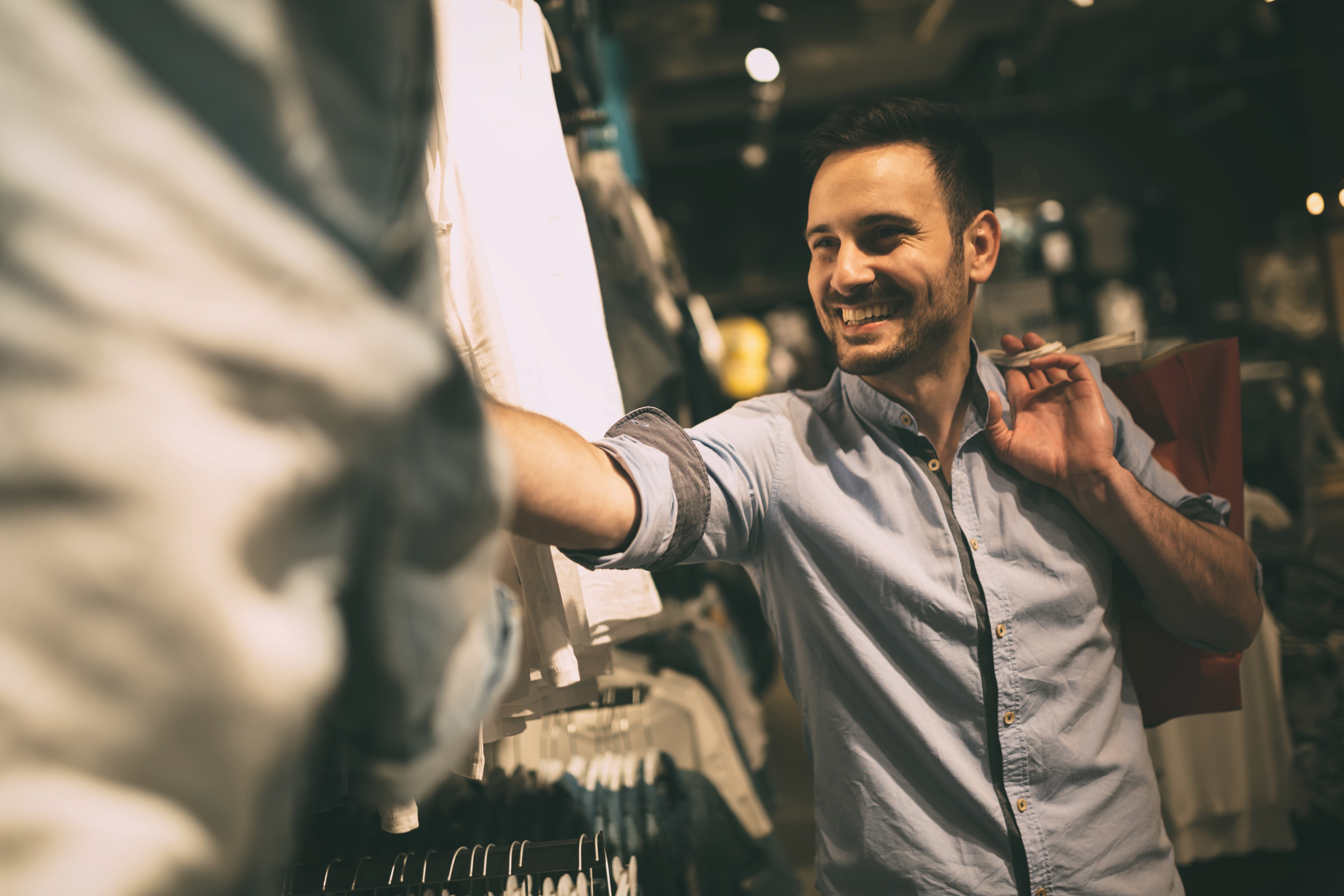 Handsome man shopping for clothes