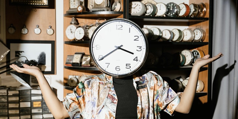 person with a clock instead of her head